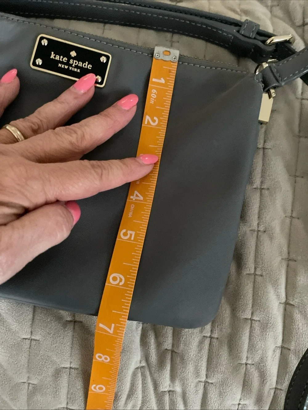 kate spade gray nylon crossbody with gold logo plaque